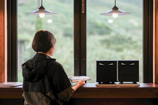 woman reading book with duet black