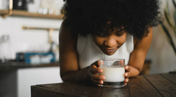 a woman smelling candle