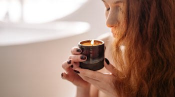 woman smelling candle